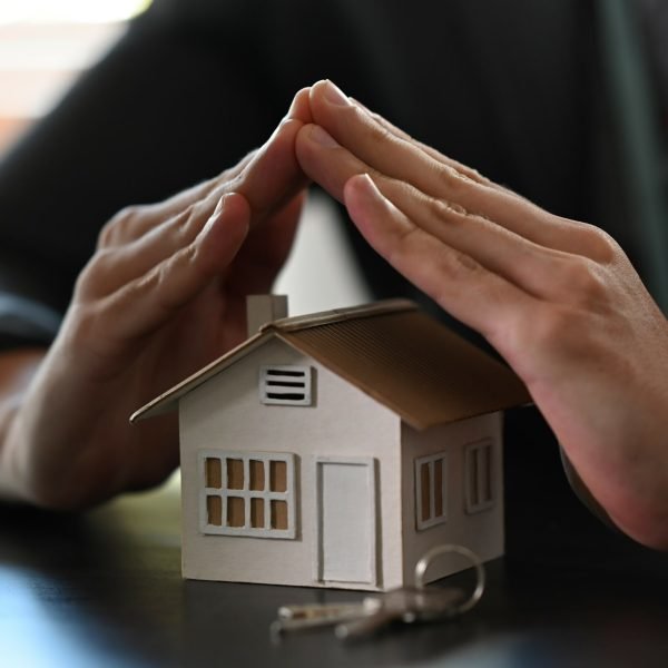 cropped-image-of-small-house-covered-by-hands-pro-2022-02-09-01-02-59-utc-2-scaled-1